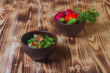 Delicious vegetable salad of fresh vegetables on a wooden table