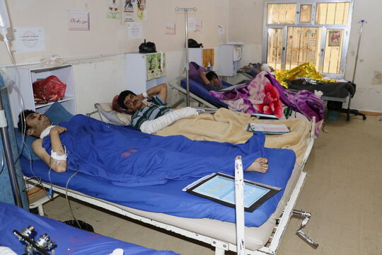 People injured by air strikes on a detention center lie on hospital beds in Saada