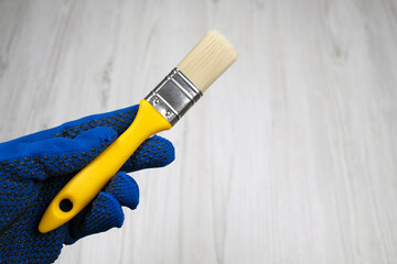 Small clean paint brush in hand, free space