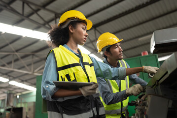 Engineer woman and team hard work with machine at factory