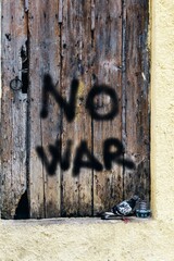 Rustic wooden door with inscription no war. Dove as a symbol of peace