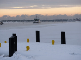 Small connection ferry coming to port during extremely cold January morning.