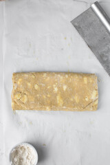 pastry dough with pieces of cold butter, process of laminating dough