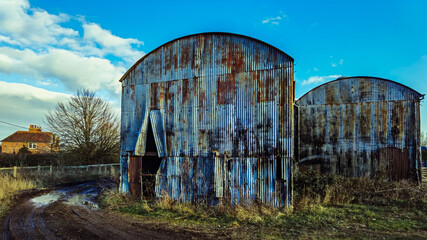 Fototapeta na wymiar Old farm with a rusty barn.