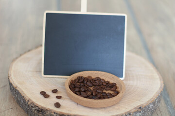 Office concept with chalkboard. Coffee beans and blank vintage chalkboard on wooden table and background, trendy design background concept. Planning idea, empty chalkboard. 