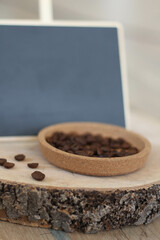 Office concept with chalkboard. Coffee beans and blank vintage chalkboard on wooden table and background, trendy design background concept. Planning idea, empty chalkboard. 
