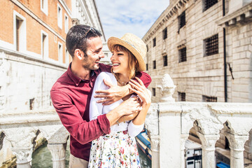 Beautiful romantic couple having fun in Venice city - Tourists traveling in Italy together in...