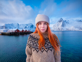 Native Icelandic girl with red hair. National traditional clothing. Sweater with patterns. Portrait of a young girl. Travel and adventure. © biletskiyevgeniy