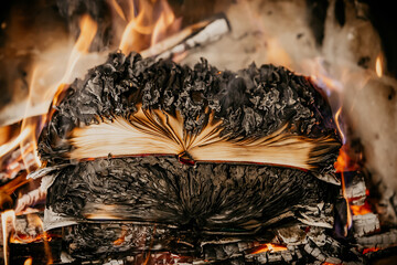 Open book is on fire, pages are engulfed in flames. Concept of censorship, prohibition of freedom...