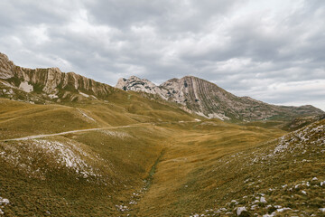 Green valley covered with snow at the Saddle Pass in Durmitor National Park