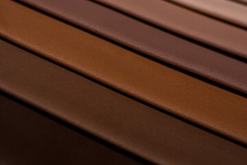 Samples of furniture fabrics.Multicolor fabric texture background.Velours.Pastel brown colors from light to dark.