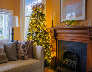 Interior of Living room of Uptown home with Decorated and Lit Christmas Tree on December 20, 2022 in New Orleans, LA, USA 