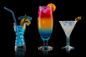 Cocktail Blue Lagoon, ice on bar counter in a restaurant, pub. Fresh drink with vodka, lemonade, blue liquor. Alcoholic cooler beverage on an isolated black background