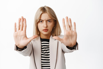 Image of businesswoman showing stop sign, stretch out arms, permission denied, prohibit gesture,...