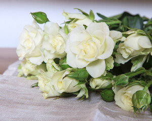 Bouquet spray white rose on a canvas tablecloth on the tabl