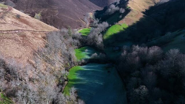 Winter landscape of forests and Pasiega cabins in the Pisue&ntilde;a River Valley. Pasiegos Valleys, Cantabria, Spain, Europe