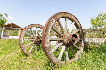 wooden wheels of an old chariot abandoned in the countryside