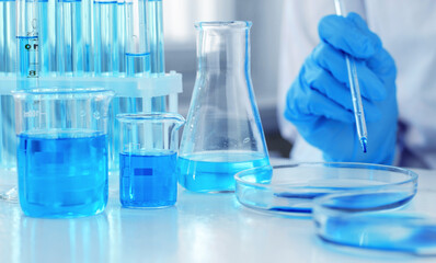 The scientist conducts research in the laboratory. Clinical trials and vaccine development. Hands of a scientist with a laboratory pipette