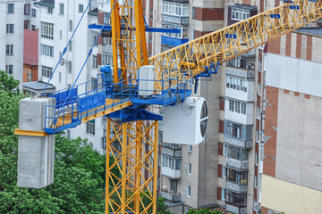 Crane and building under construction against blue sky