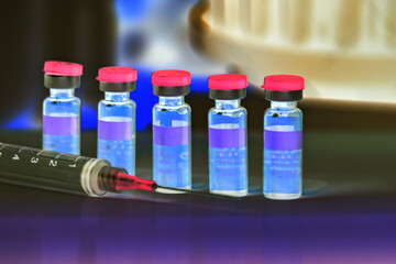 syringe and vials of injectable drugs - green