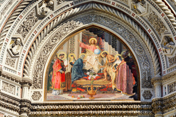 Fototapeta na wymiar Christ enthroned with the Mother of God and Saint John the Baptist. Cathedral of Santa Maria del Fiore. Facade. Florence. Italy. Tuscany