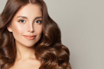 Naklejka premium Beautiful woman with stylish curly hairstyle smiling, female model face close up