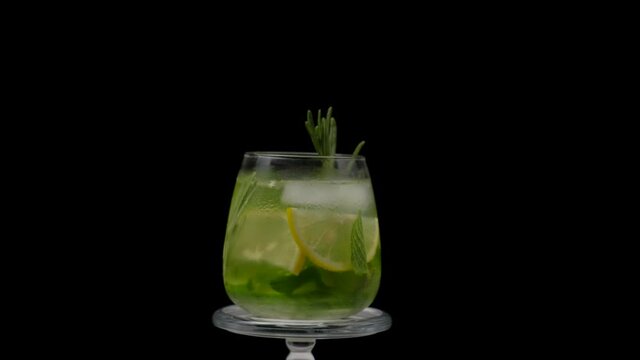 Water detox with cucumber, lime and rosemary on a black background.