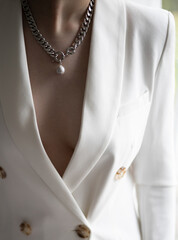 Woman wearing elegant pendant necklace with pearl on close-up