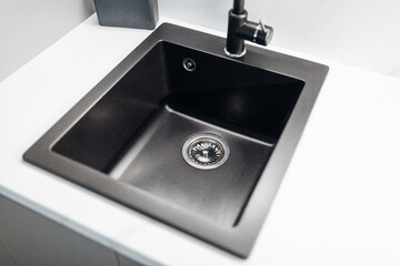 Modern, carbon sink at the white luxury kitchen