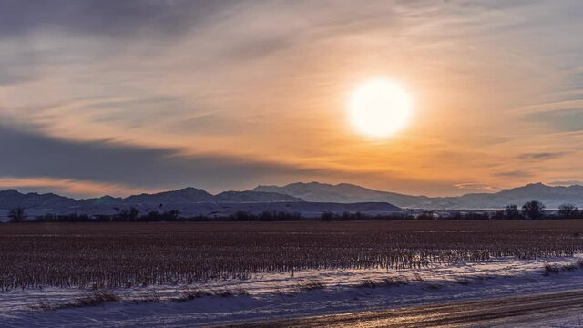 time lapse view of cloudy sunset over the rocky mountain range in southeast wyoming in winter