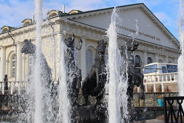 Part of the monument in the form of bronze horses installed in the fountain with pouring water jets in Moscow.