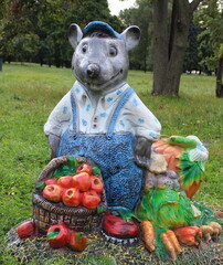 Decorative figure of a fairy-tale mouse character with ceramic vegetables.