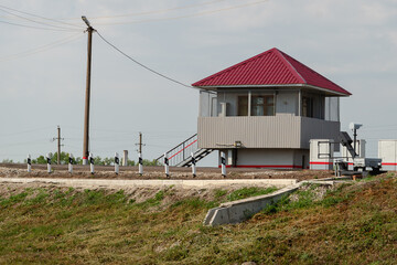 Fototapeta na wymiar Small house at the railroad crossing.