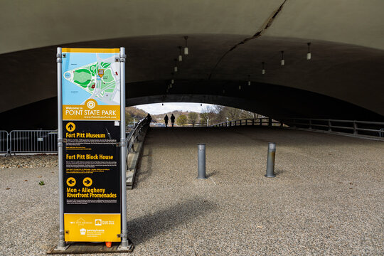 Pittsburgh, PA - April 2, 2021: Directions sign and map for Point State Park, Fort Pitt Museum and the Fort Pitt Block House at a pedestrian walkway under a bridge on the Three Rivers Heritage Trail.