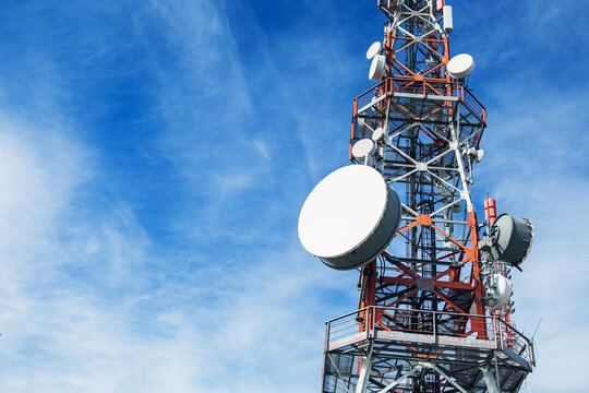 Telecommunication tower. Communication and connection. Wireless antene. Blue sky with clouds in background.