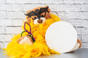 Mardi Gras Mockup, Wooden empty round sign template with stuffed toyTeddy Bear in carnival mask and golden boa, copyspace