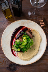 Grilled duck meat with salad on plate. Closeup.
