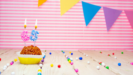 Happy birthday for 65 years old. Festive background with muffin. Copy space birthday card for...