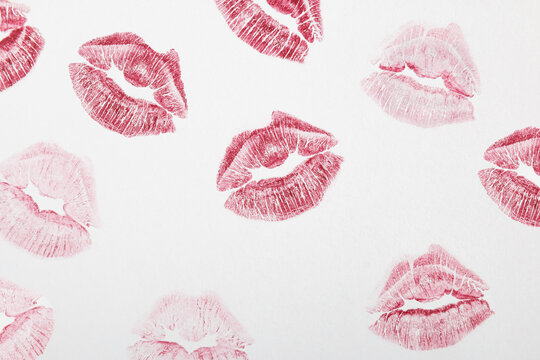 Red lipstick marks on a white background. Kiss symbol. Minimal love concept.Flat lay.