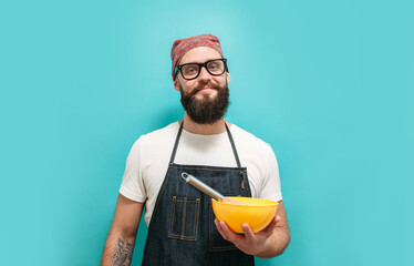 Profession charismatic chef cook holding bowl and whipping something with whisk. Copyspace for ad. Time to cook