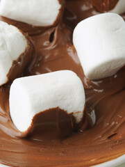 macro photography. Appetizing pieces of white marshmallow in chocolate cream. Delicious calorie breakfast, sweet food, restaurant, hotel, patisserie, supermarket.
