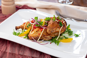 fried chicken tobacco with vegetables on a white plate