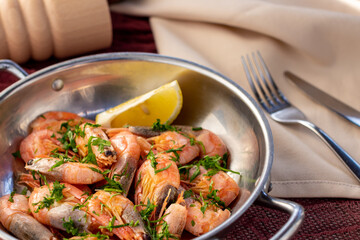 boiled shrimp on a cast iron pan with lemon