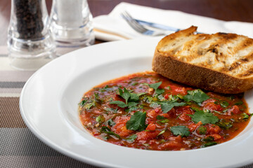 Soup cream of tomato with greens and fried croutons