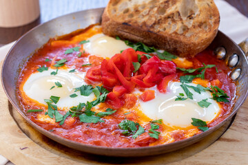 shakshuka classical on the board on cast iron pen