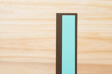 green and brown card stock rectangles on wood