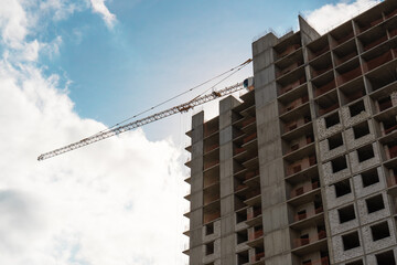 Fototapeta na wymiar Tower crane at construction site during building construction.