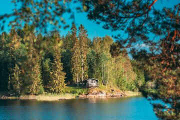 Sweden. Beautiful Swedish Wooden Log Cabin House On Rocky Island Coast In Summer Sunny Evening....