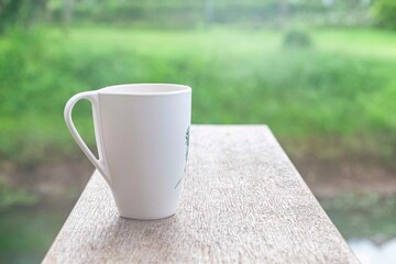 The coffee mug placed on the white wood table