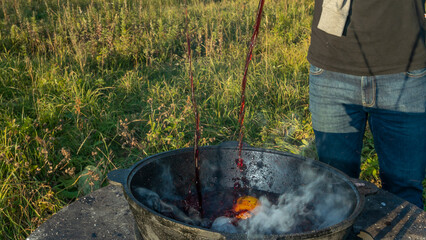 Mulled wine in a tourist pot over hot camp fire. Mulled wine by the fire. Mulled wine cooked on...
